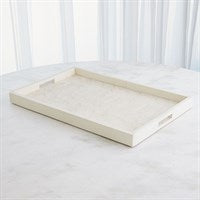 The Global Views/Surya Searchlight Tray Ivory, a rectangular cream-colored decorative piece with raised edges and an elegant finish, rests on a marble-like surface with sheer white curtains in the background.