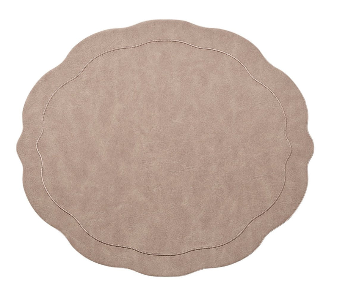 The Kim Seybert Tailored Placemat Taupe Set of 4 features round, taupe faux leather placemats with wavy, scalloped edges and subtle stitched borders, shown isolated on a white background.