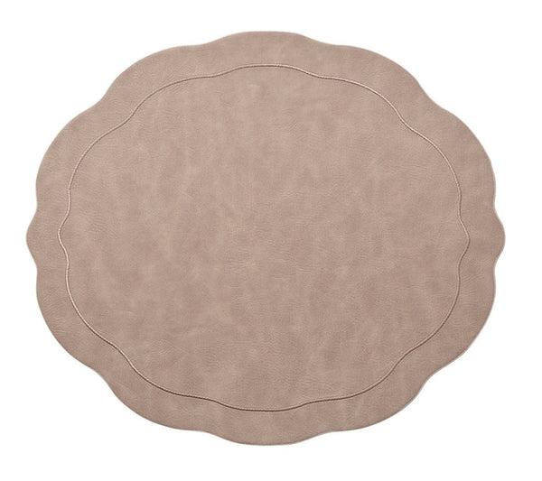 The Kim Seybert Tailored Placemat Taupe Set of 4 features round, taupe faux leather placemats with wavy, scalloped edges and subtle stitched borders, shown isolated on a white background.