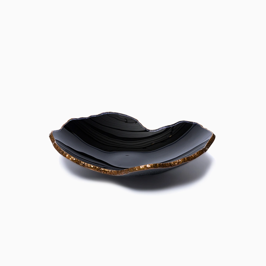 The Gardeco Mapa Bowl Black & Bronze Trim - Mini is a handcrafted bowl with a wavy black form, an uneven rim, and bronze trim, shown against a plain white background.