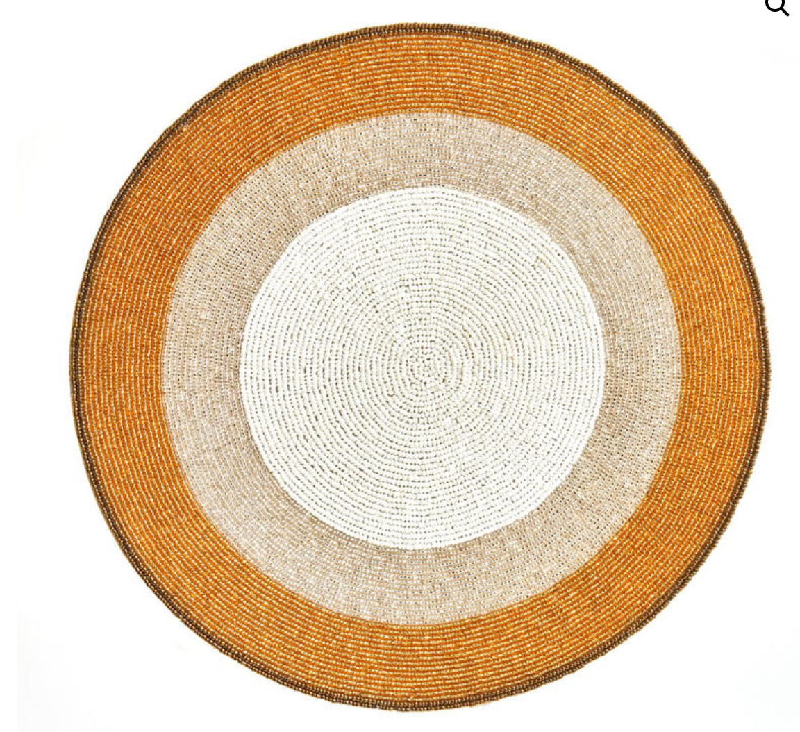 The Graphic Sparkle Placemats Set of 4 by Von Gern Home features round beaded designs in white, beige, and gold, adding sophisticated metallic style to your table—ideal for elegant decor.