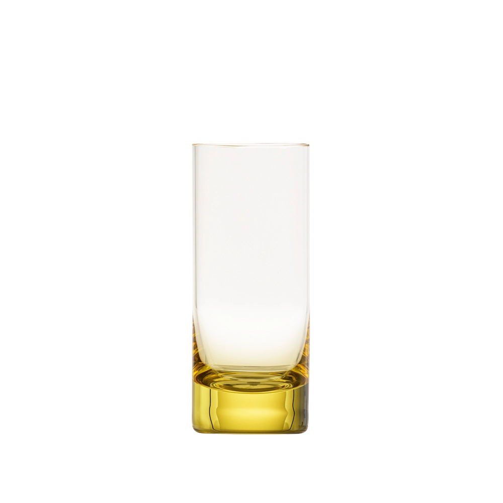 The Moser Whiskey Spirit Glass is a tall, cylindrical crystal shot glass with a thick, solid yellow base. It stands upright and empty on a white background.