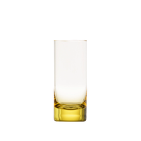 The Moser Whiskey Spirit Glass is a tall, cylindrical crystal shot glass with a thick, solid yellow base. It stands upright and empty on a white background.