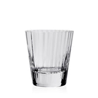 The Corinne Drinkware by William Yeoward is a clear, empty glass tumbler featuring vertical etched lines for an optic effect, adding contemporary barware style against a plain white background.