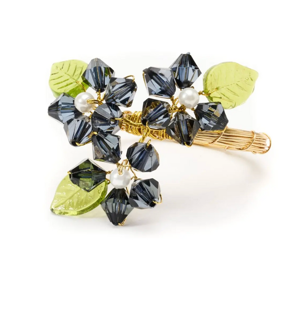 The Deborah Rhodes Floral Spray Napkin Ring Set of 4 features flower designs with dark crystal beads, white pearl centers, and green glass leaves on a gold-toned base—ideal for fans of elegant details and beaded décor.