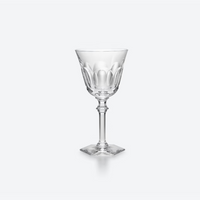 A Baccarat Eve Wine Glass with a faceted bowl, slender stem, and square base is set against a plain white background.