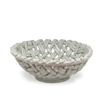 The Skyros Woven Basket - Round-15" is a glossy, light gray ceramic bowl featuring an open, basket-inspired motif with thick, interlaced ribbons.