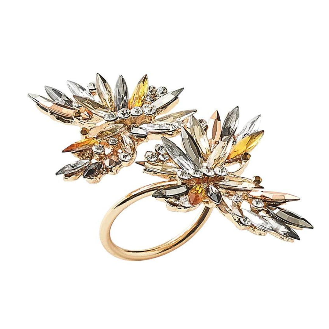 The Butterflies Napkin Ring Set of 4 by Kim Seybert features layered, gold-tone butterfly designs embellished with sparkling crystals and rhinestones for an elegant, eye-catching table accent.