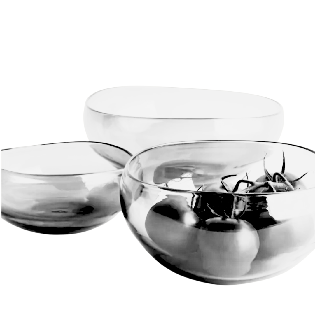 The Gary Bodker Nesting Bowl Collection Clear features three elegant bowls arranged together on a white background, with one filled with tomatoes and the others empty.