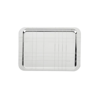 The Christofle Graphik Silver Plated Rectangular Tray features a shiny finish with an engraved grid pattern, rounded corners, and modern elegance. Part of the GRAPHIK collection, it is shown against a plain white background.