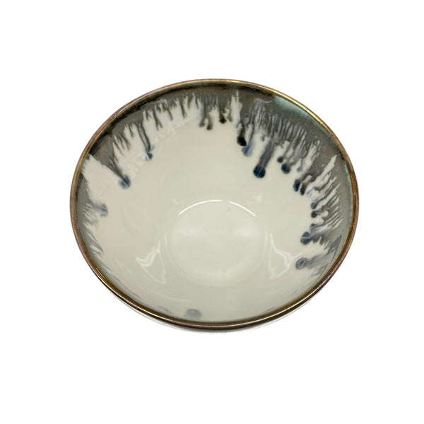 The Michael Wainwright Fjord Dip Bowl features a glossy white interior with a dark blue and gray drip pattern around the rim—perfect for elevating your table setting.