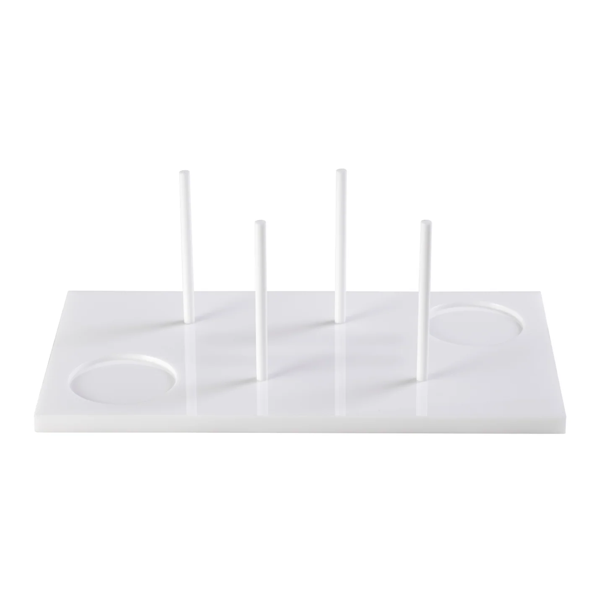 The Acrylic Bagels On Board Tray - White by Inspired Generations is a white rectangular acrylic tray featuring four vertical rods and two circular indents, perfect for organizing or holding items upright—an ideal and stylish choice for serving bagels at your next brunch board.