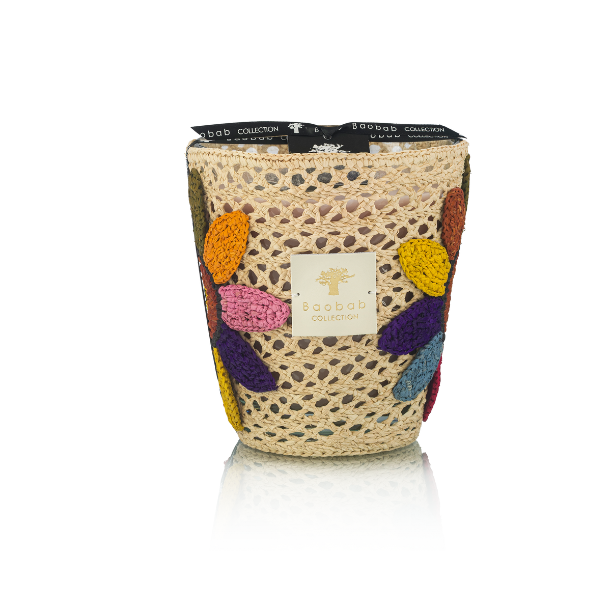 The Baobab Tournesol Girasol Candle features a decorative woven holder with colorful crocheted flower petals, a black ribbon, and the Baobab label for a vibrant touch to any home décor. Set against a white background.