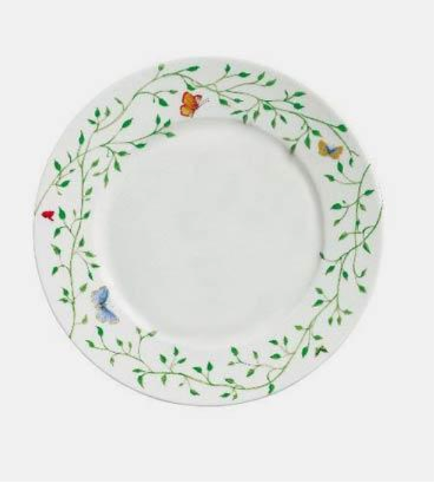 The Histoire Naturelle Dinnerware by Raynaud features a white plate adorned with green vines, leaves, butterflies, a red ladybug, and rare birds—ideal for adding French elegance to any table setting.