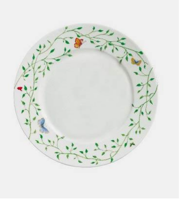 The Histoire Naturelle Dinnerware by Raynaud features a white plate adorned with green vines, leaves, butterflies, a red ladybug, and rare birds—ideal for adding French elegance to any table setting.