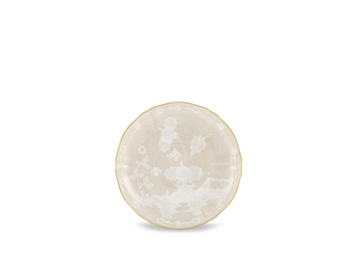 The Ginori 1735 Oriente Italiano Beige Meringa is a round, shallow porcelain bowl with a delicate floral pattern and gold rim, set against a plain white background.