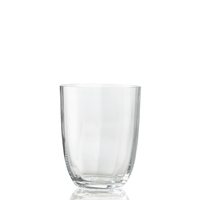The Idra Tumbler Optic by Nason Moretti is displayed empty against a white background, with a subtle reflection beneath highlighting its clear glass design.