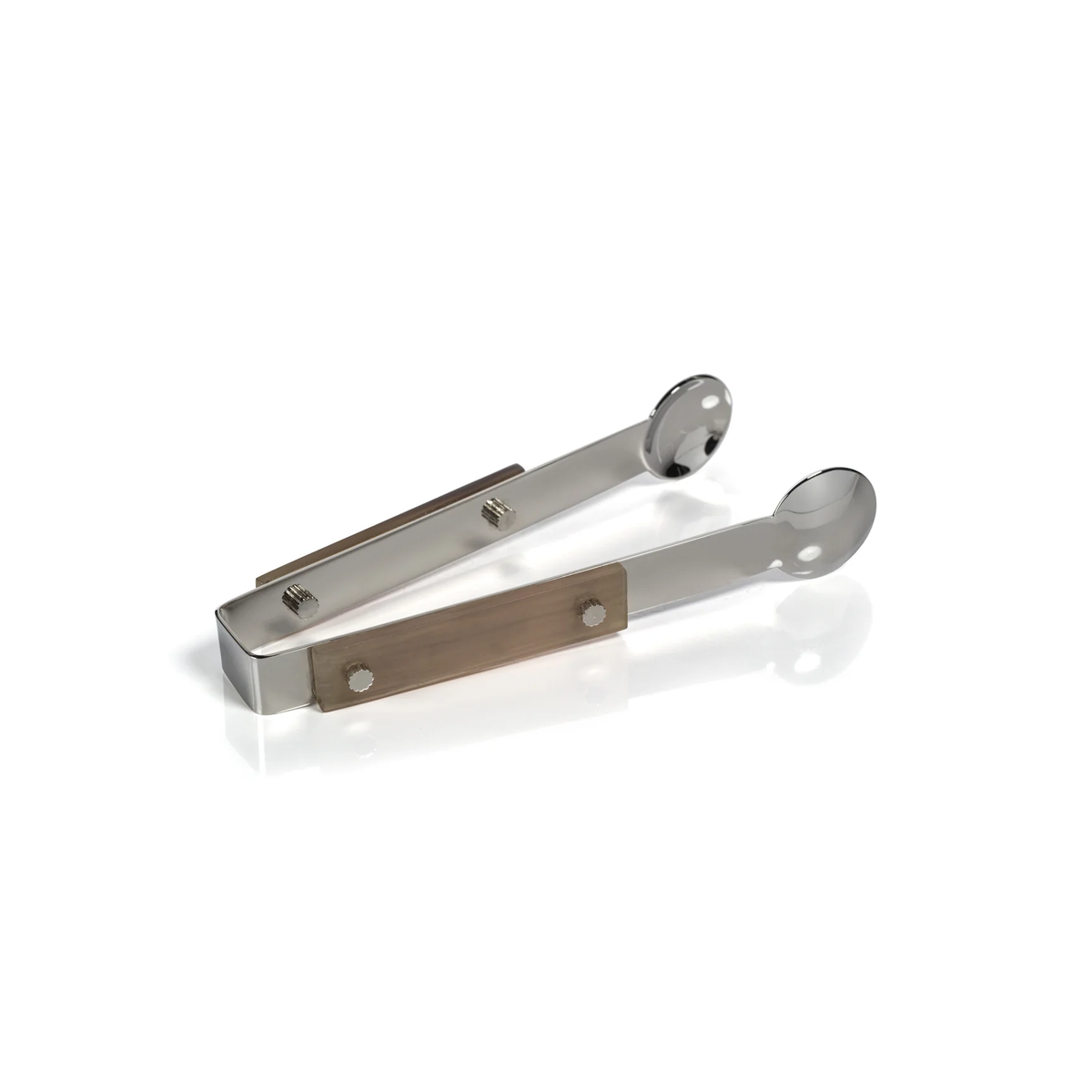 The Zodax Belmont Ice Tong features stainless steel construction with flat handles and rounded, pinched gripping ends, shown resting on a white surface with a subtle reflection.
