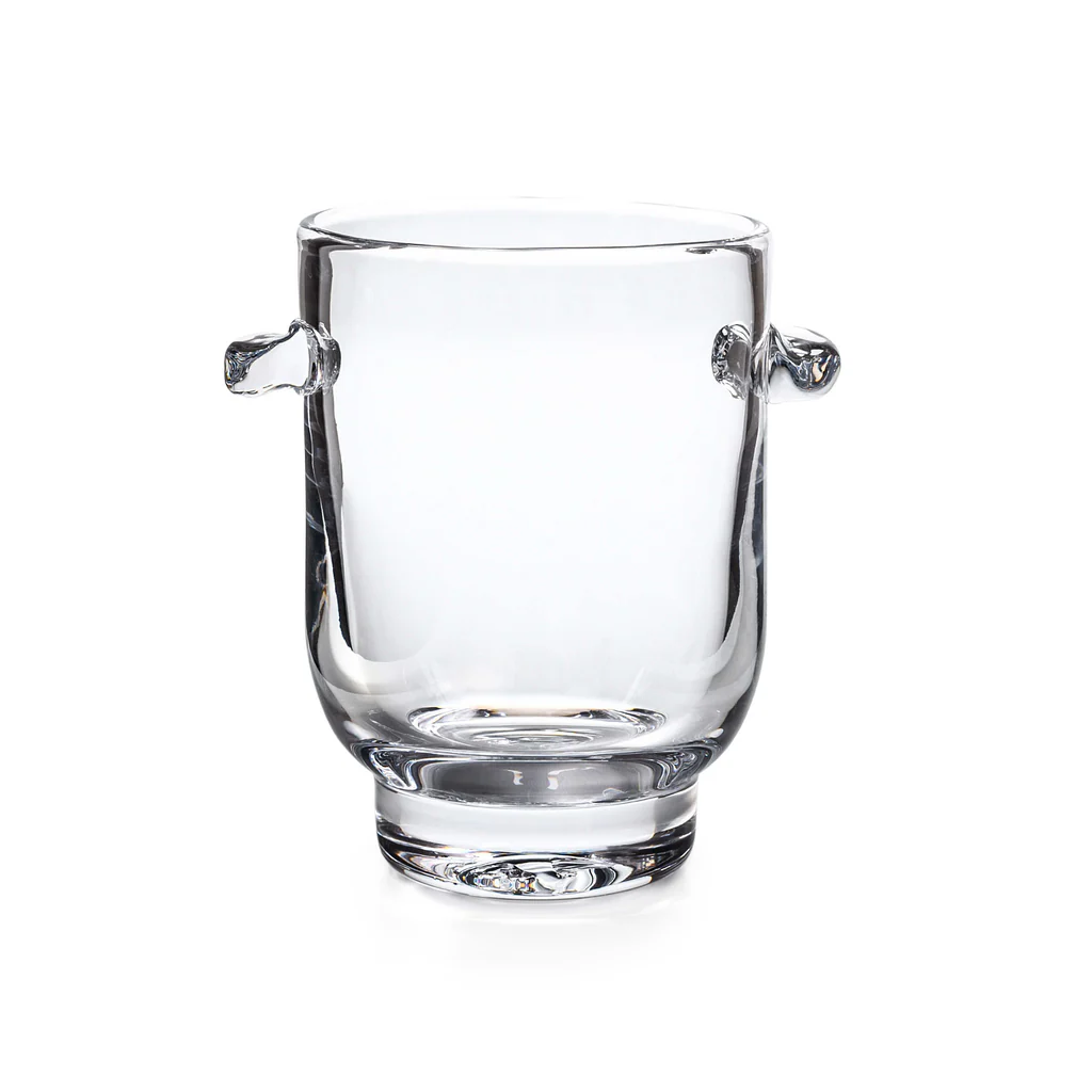 The Simon Pearce Manchester Ice Bucket is crafted from clear glass with two small, rounded handles on opposite sides, shown against a white background.