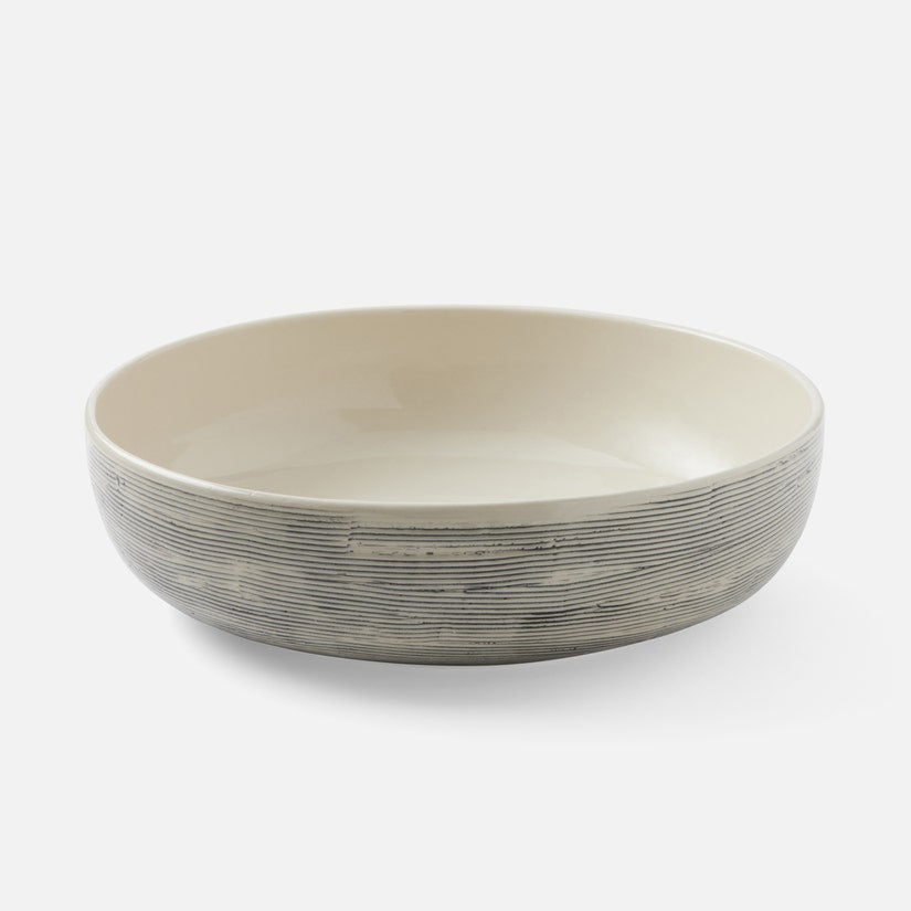 The Nolan Dinnerware Black Cream bowl by Blue Pheasant features a cream interior and textured gray-striped exterior, crafted in ceramic and displayed against a plain white background.