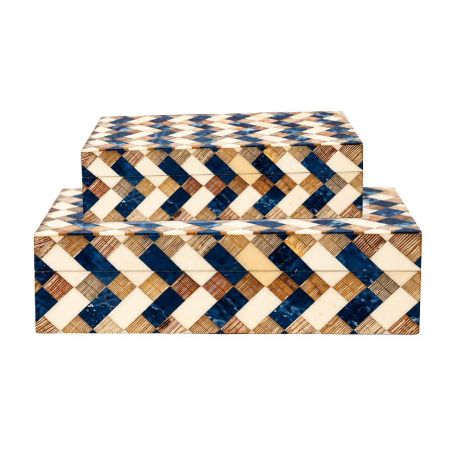 Stacked Brett Bone Boxes from A Sanoma Inc showcase a modern design with a geometric pattern of alternating cream, blue, and brown diagonal stripes. Their glossy, tiled finish and clean, sharp edges make these rectangular decorative boxes the perfect accent for any contemporary space.
