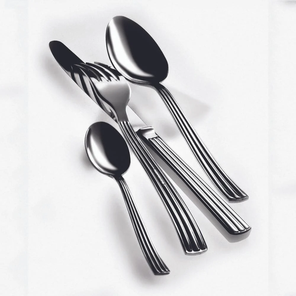 The Mepra Sole Flatware 5 Piece Setting in stainless steel, made in Italy, includes a knife, fork, large spoon, small spoon, and is displayed neatly on a white surface.