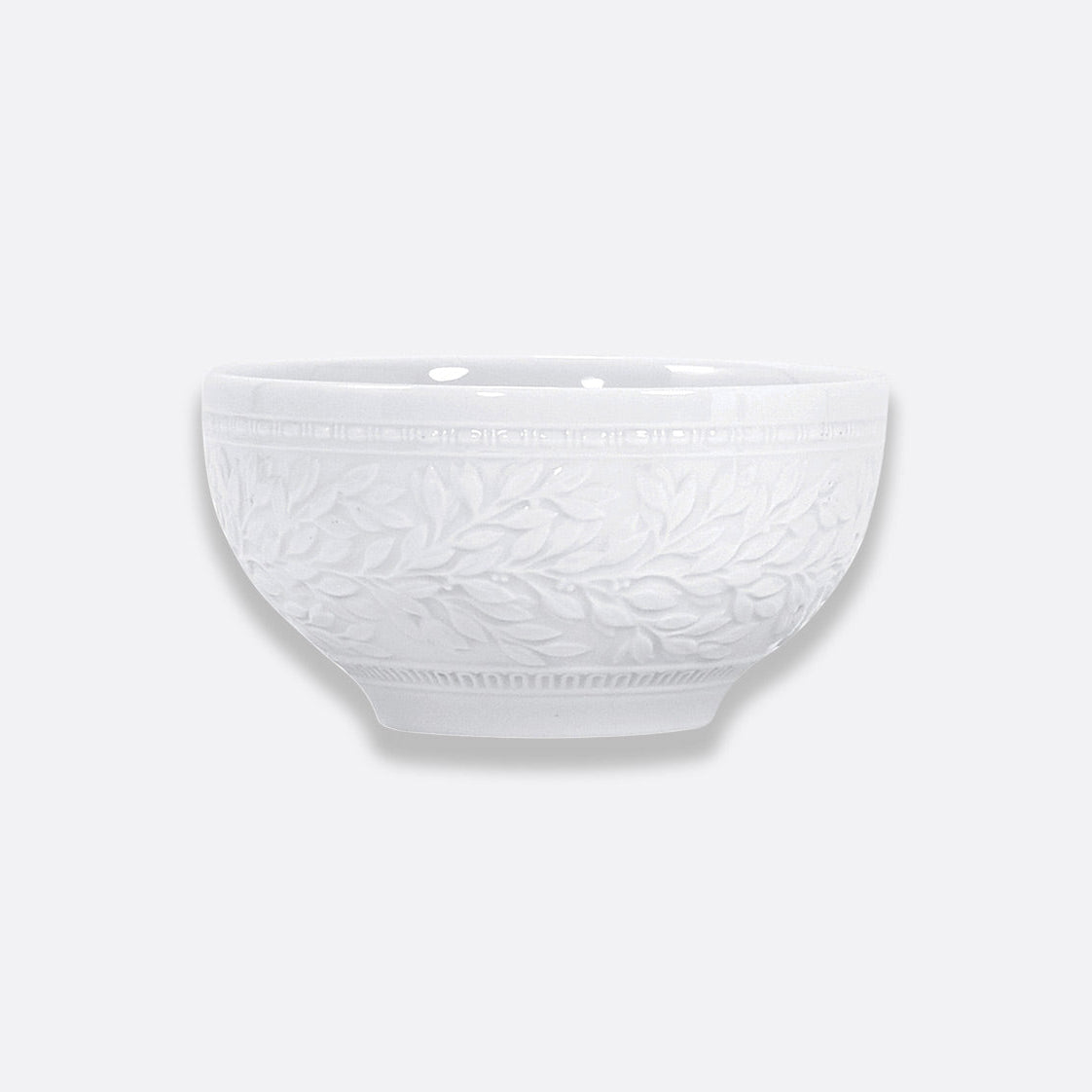Bernardaud's Louvre Dinnerware: a white ceramic bowl featuring an embossed leaf and vine pattern inspired by Renaissance elegance, displayed against a plain light gray background.