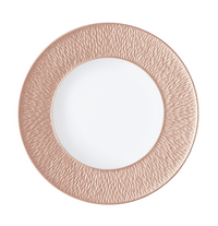 A rose gold charger plate with a textured rim, crafted to pair with Raynaud's Mineral Irise Dinnerware-Copper, sits elegantly on a white background.