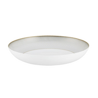 The Oskar Dinnerware by Raynaud is a white ceramic bowl featuring a gold geometric interior design and a slim gold rim, evoking the elegance of classic Limoges porcelain.