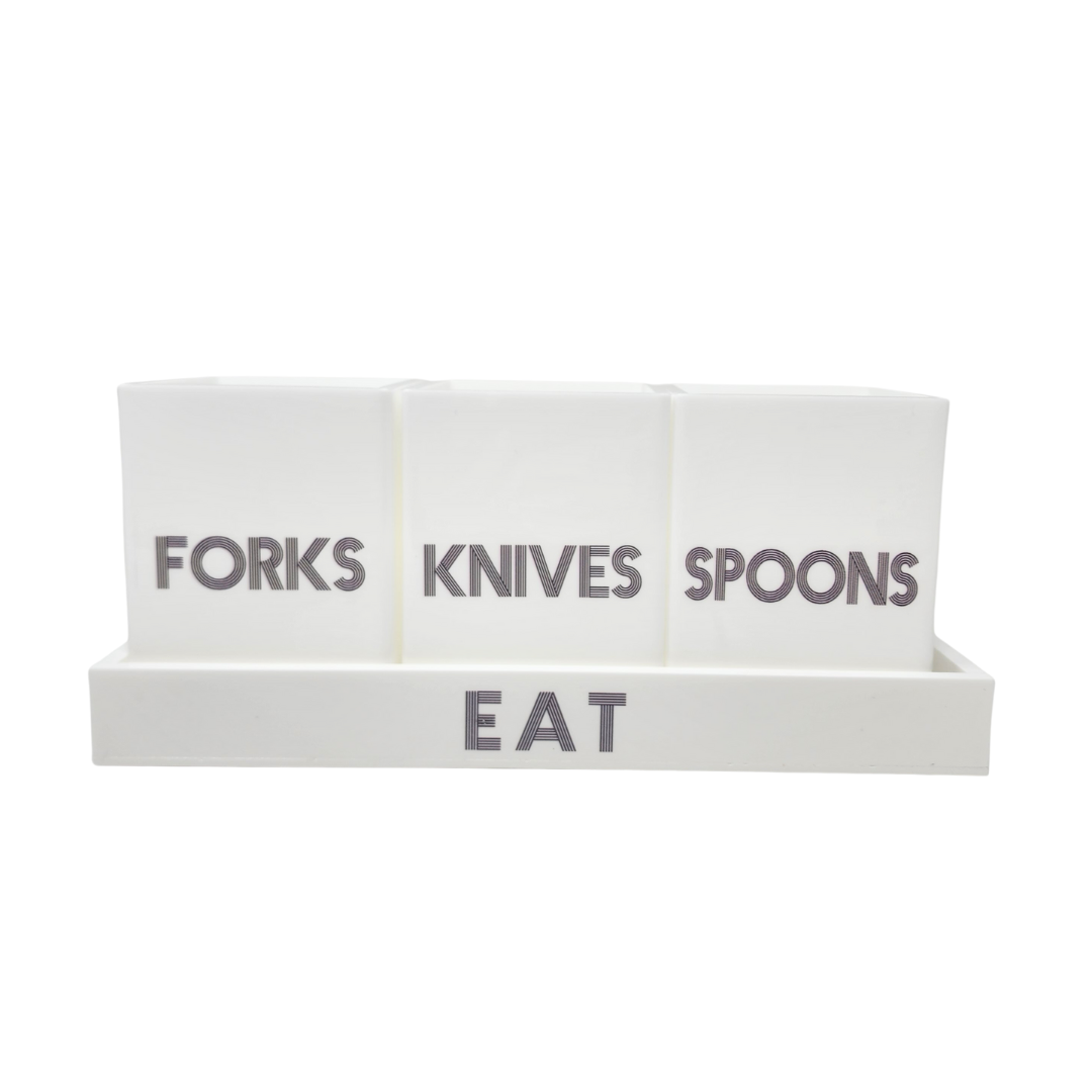 The Eye Candy Let's Eat Silverware Caddy in white with dark grey features containers for forks, knives, and spoons in a stylish tray labeled EAT, keeping your cutlery neatly organized and easy to access.