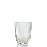 The Idra Tumbler Rigadin by Nason Moretti is a clear glass tumbler featuring vertical ribbed lines, shown empty on a white reflective surface with a plain white background.