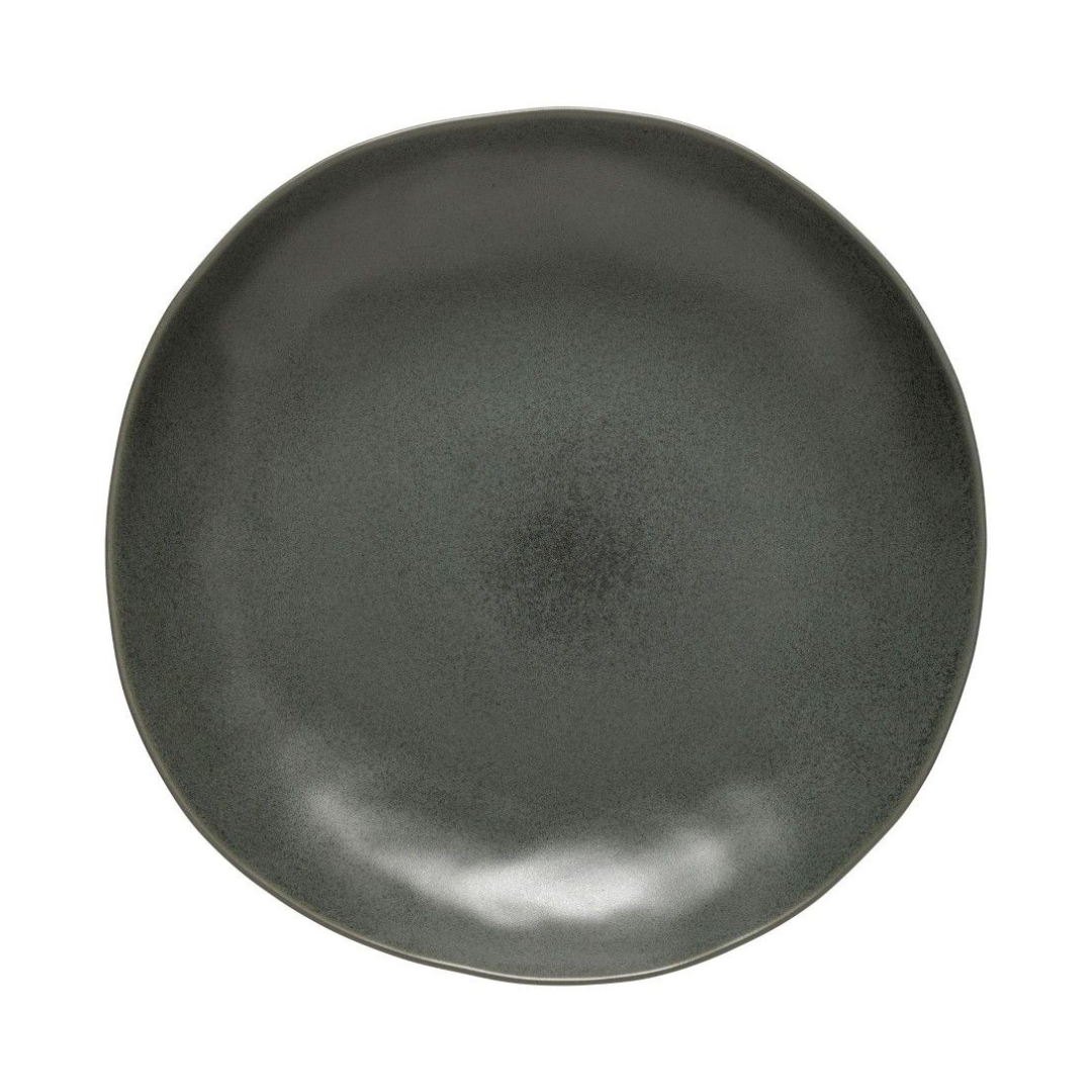 The Livia Dinnerware Matte Black plate by Casafina/Costa Nova features a round, organic-shaped edge and smooth matte finish with subtle color variations, crafted in Portugal as part of a modern collection. Shown against a white background.