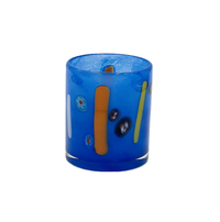 The Abigails Torcello Stripes Cobalt DOF is a blue mouth-blown glass tumbler with a matte finish, featuring orange and yellow stripes and multicolored dots—a vibrant addition to your colorful glassware collection.