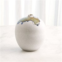 The Volcan Reactive Glaze Vase by Global Views / Surya is a round, light-toned artisanal piece with a narrow opening and glossy, multicolored glaze accents. It’s shown in soft light against sheer white curtains.