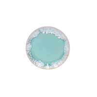 Taormina Aqua dinner plate with a smooth, solid aqua center and a textured, scalloped edge in shades of white and blue.