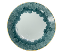 The Marie Daâge Cercle D'Ecailles Gold Filet plate by Marie Daâge features a gold rim and blue-green scalloped edge on white ceramic, offering an elegant, hand-painted design inspired by classic French tableware.
