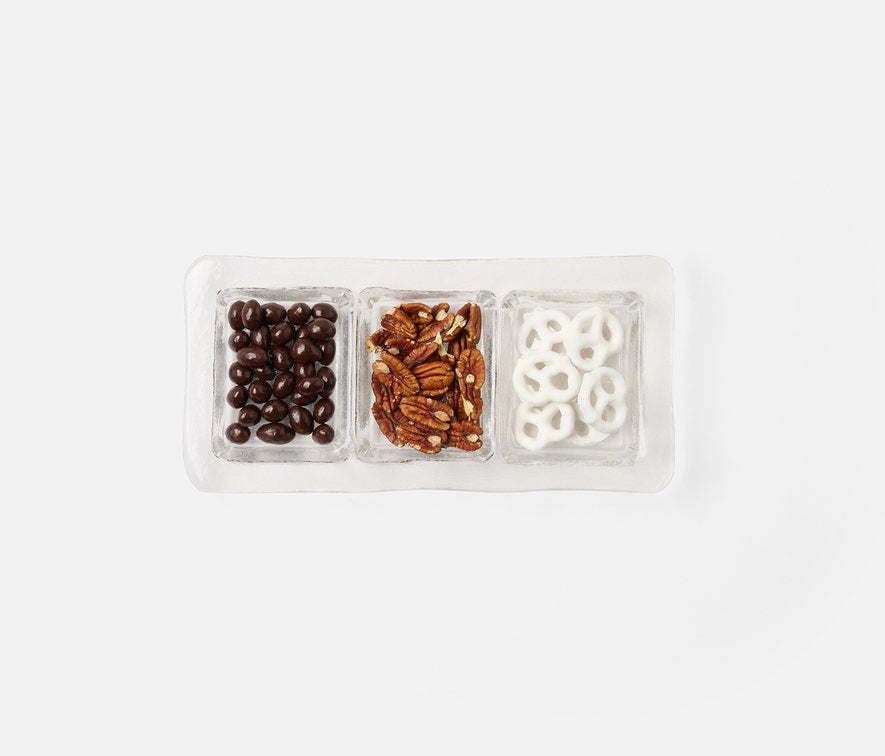 The Blue Pheasant Livingston 3 Section Serving Tray in clear displays chocolate-covered coffee beans, pecan nuts, and white yogurt-covered pretzels, all neatly arranged side by side on a white background.