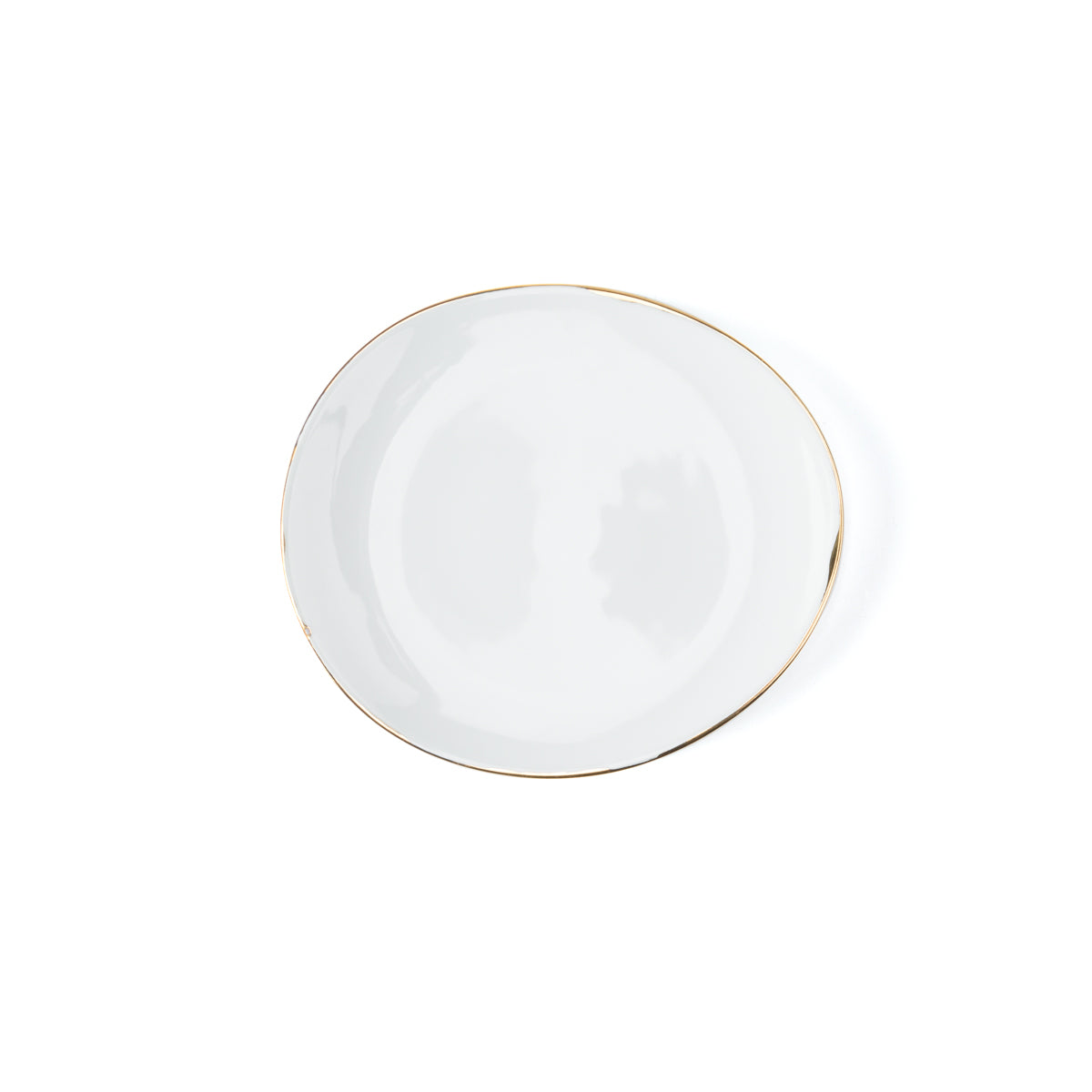 The Molecot Simply Gold Dinnerware plate features plain white Limoges porcelain with a slightly irregular shape and a thin gold rim—an elegant piece for any gold dinnerware collection, shown here on a white background.