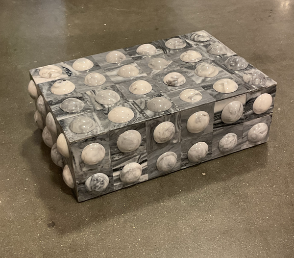 The Moondrops Grey & White Box by A Sanoma Inc is a rectangular jewelry storage box with a marbled finish and smooth dome-shaped bumps, making it a stylish decorative accent for concrete floors.