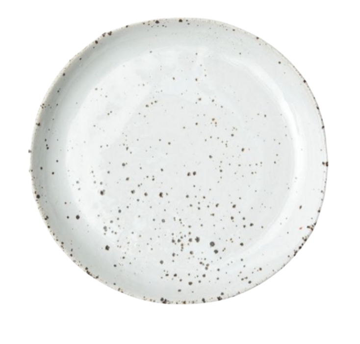 The Marcus Dinnerware - White Salt Glaze - Set of 4 by Blue Pheasant features round white ceramic plates with dark speckles and slightly uneven rims, highlighting handcrafted charm against a crisp white background.