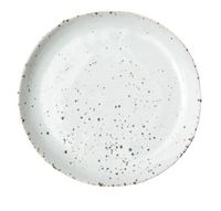 The Marcus Dinnerware - White Salt Glaze - Set of 4 by Blue Pheasant features round white ceramic plates with dark speckles and slightly uneven rims, highlighting handcrafted charm against a crisp white background.