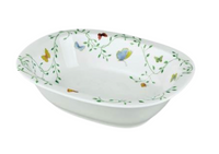 The Raynaud Histoire Naturelle Dinnerware is a white rectangular ceramic bowl featuring colorful butterflies, rare birds, and green vines along the inner rim for an elevated dining experience.