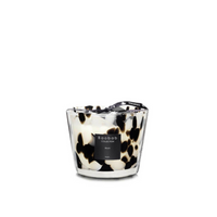 The Baobab Pearls Candle is a hand-blown glass candle with a black and white spotted design, tied with a black ribbon. This luxurious candle features the Black Pearls scent, combining notes of ginger and black rose.