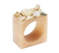 Add an ivory floral touch to your elegant table decor with the Ivory Petal Napkin Ring Set of 4 from Bodrum—each square beige ring features a large opening and is beautifully adorned with decorative beads and flowers arranged along the top edge.