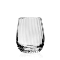 The Corinne Drinkware by William Yeoward is a clear crystal glass with a rounded, slightly tapered shape and textured base, standing upright on a white background—an elegant piece of contemporary barware.