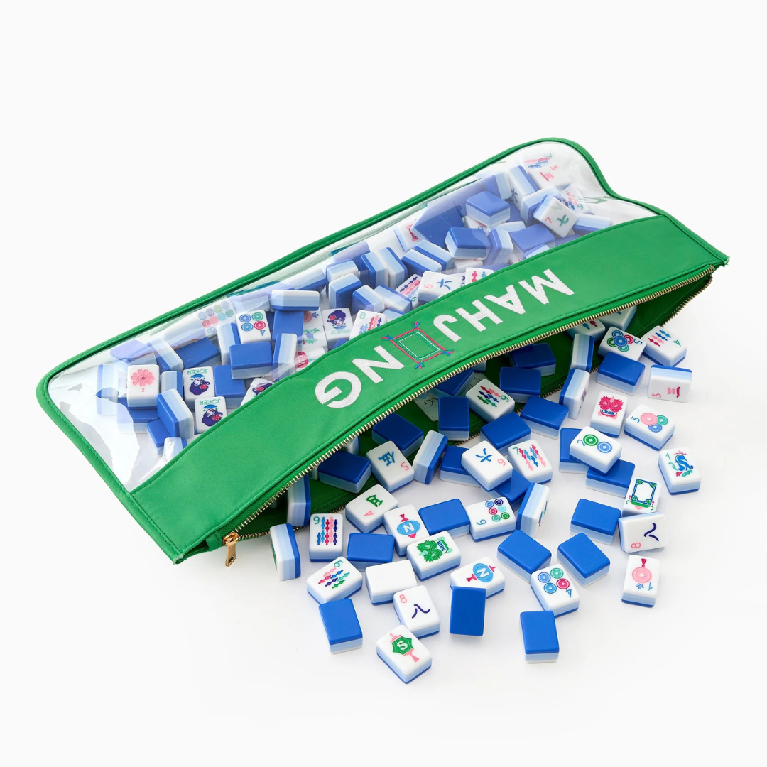 The Oh My Mahjong Mahjong Tile Bag is a green zippered case labeled "MAHJONG" with a clear top, shown open and spilling white and blue tiles with colorful symbols, keeping your game pieces organized and accessible.