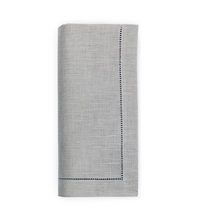 The Sferra Festival Napkin Set of 4 features neatly folded light gray European linen napkins with a decorative stitched border on two edges, shown against a white background.