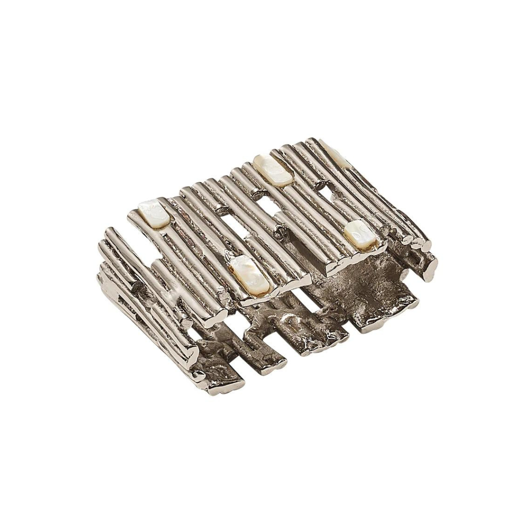 A gold-toned, textured metal Matrix napkin ring by Kim Seybert, featuring an open geometric design and small rectangular white accents reminiscent of mother-of-pearl embedded on the top surface; sold as a set of four.