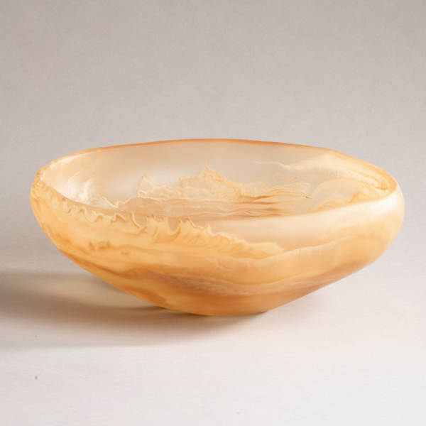 The Mayan Resin Bowl by CDMX / MONICA CALDERON is a handmade, shallow round bowl from Mexico with warm beige and caramel waves in translucent resin—perfect as a serving piece. Photographed on a plain light background.