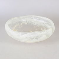 Handmade in Mexico, the Mayan Resin Bowl by CDMX / MONICA CALDERON features a translucent white finish with a cloudy, marble-like pattern and smooth, irregular edges—a unique serving piece that brings elegance to any table.